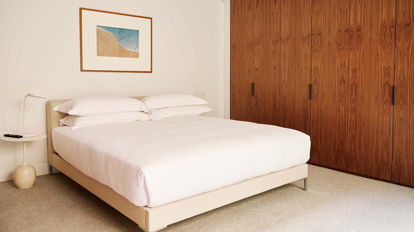Bedroom with a run of walnut wardrobes