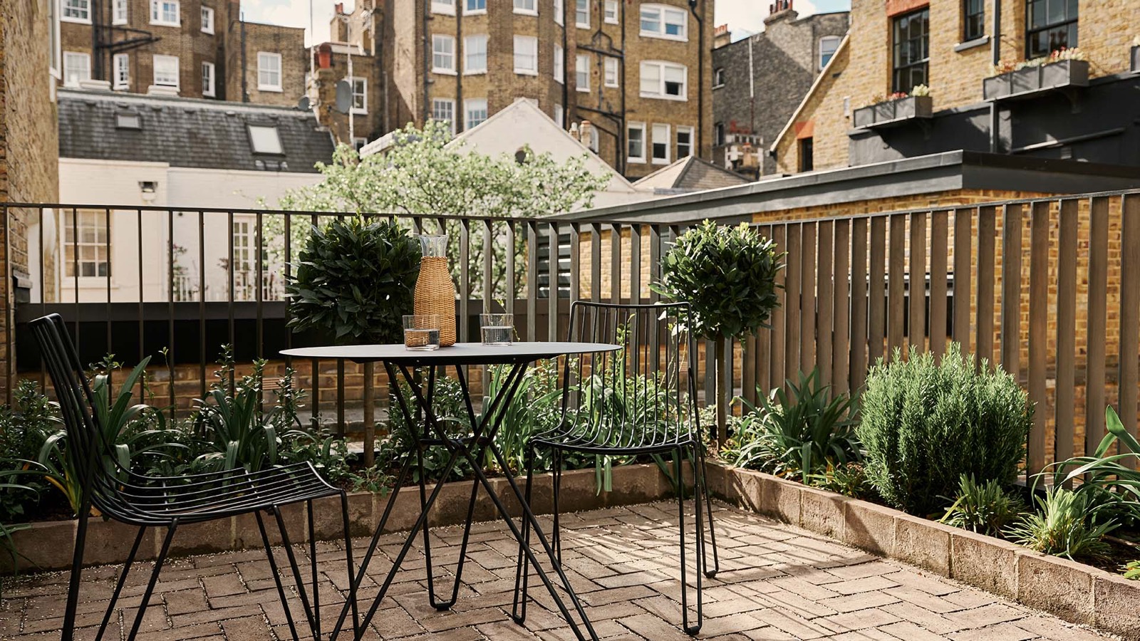 Terrace table among the planted beds